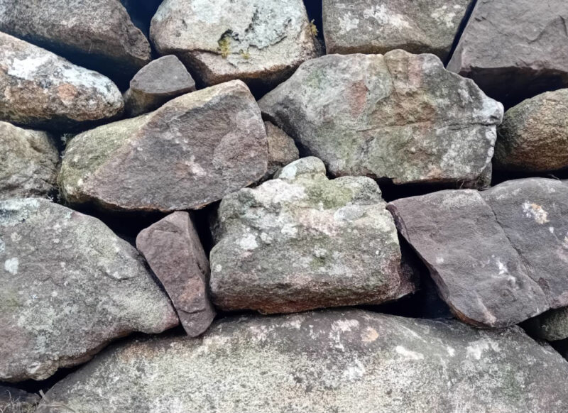 close-up of close-fitting Torridonian standstone stones in a wall I built in Stoer